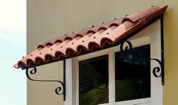 Clay tile window awning with wrought iron brackets