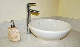 Corian bathroom countertop with modern vessel sink