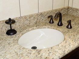 Granite bathroom countertop with recessed sink and oil rubbed bronze faucet
