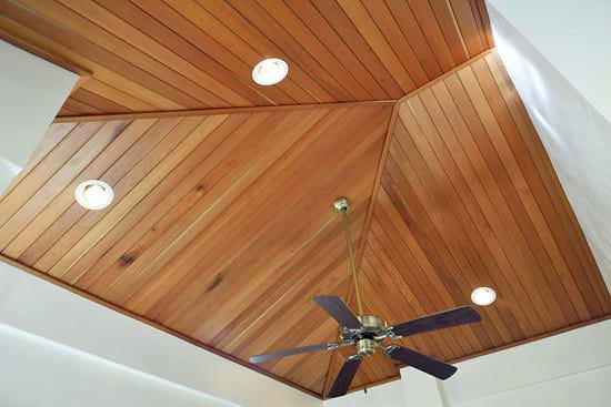 Cedar wood ceiling with recessed lighting and ceiling fan