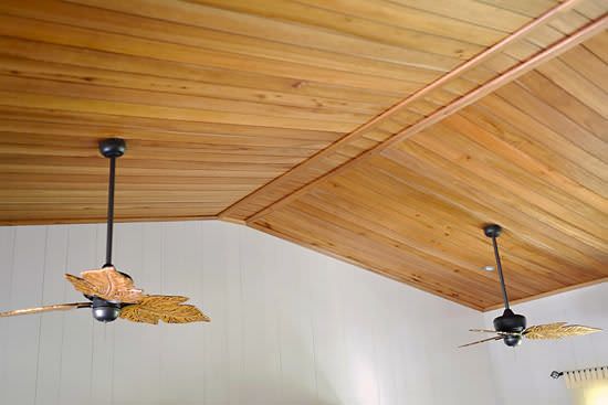 Wood ceiling with recessed lighting and leaf blade ceiling fans