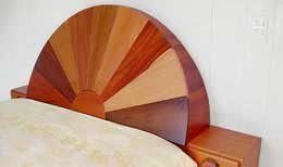 Custom-made tropical hardwood bed with half-moon headboard