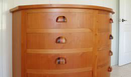 Custom-made half-moon chest of drawers made out of tropical hardwood