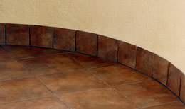 Detail of curved wall, tile floor and baseboard
