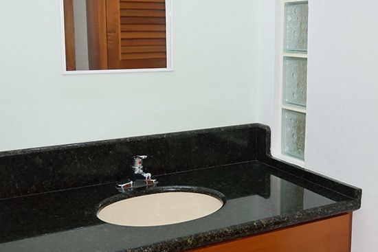 Black Corian bathroom countertop with recessed sink